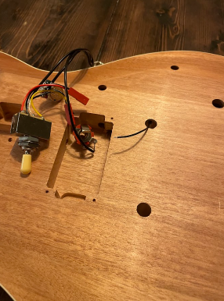 Placeholder text — unfinished physical prototype, showing the routed body cavity with the servo and wiring loosely fitted for a first mechanical test.